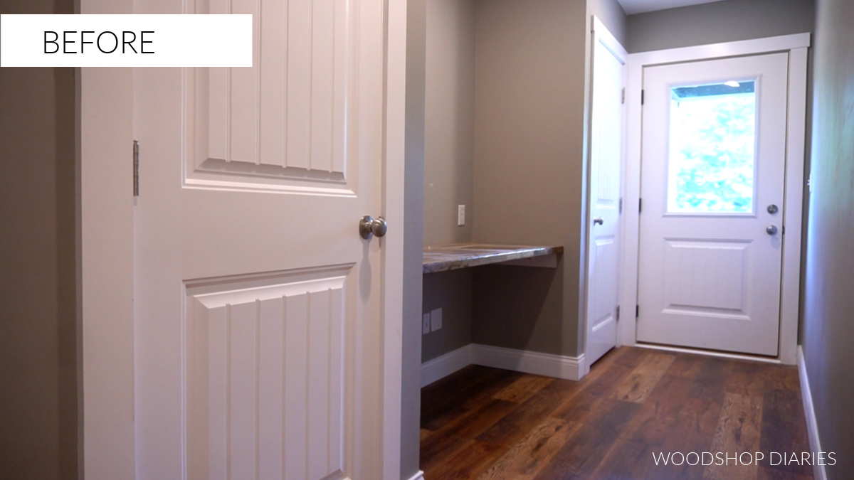 Before image of hallway with dark gray walls and white doors--The DIY hallway makeover "before"