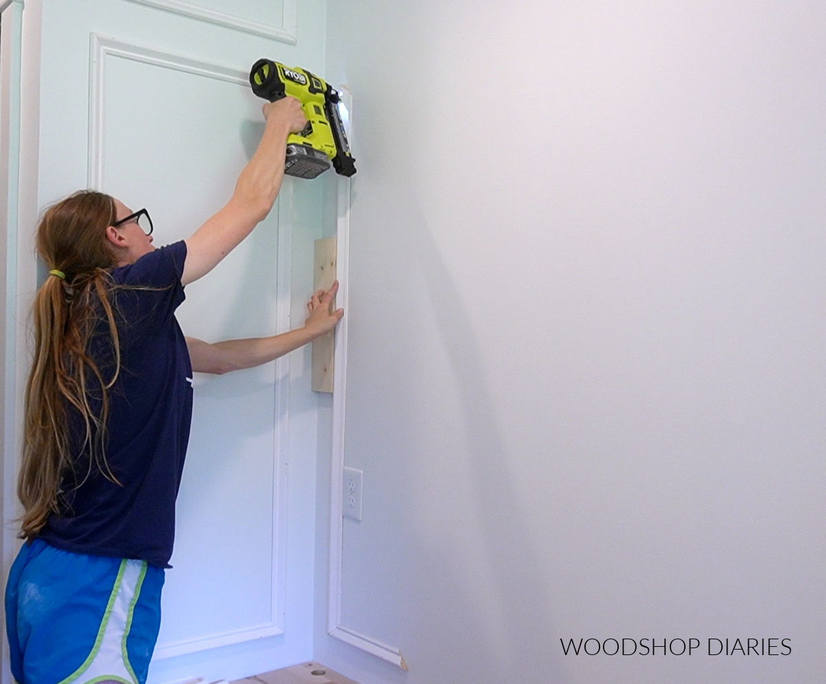 Shara Woodshop Diaries using nail gun to install picture frame molding using scrap wood spacer block