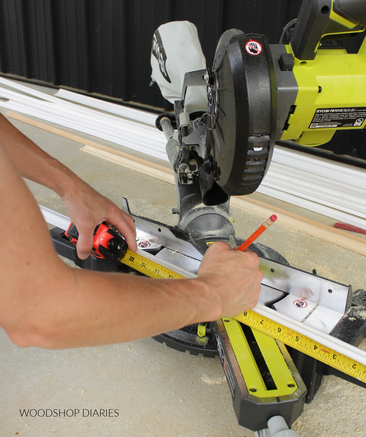 Marking base cap molding using measuring tape on miter saw