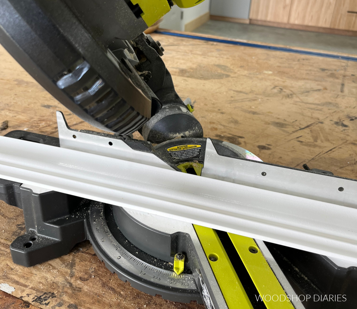 Close up of crown molding placed in miter saw for an inside corner cut