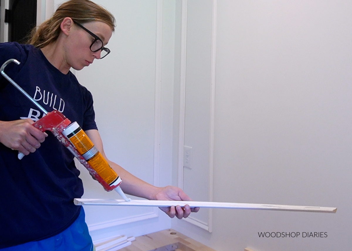 Shara Woodshop Diaries applying construction adhesive to base cap molding