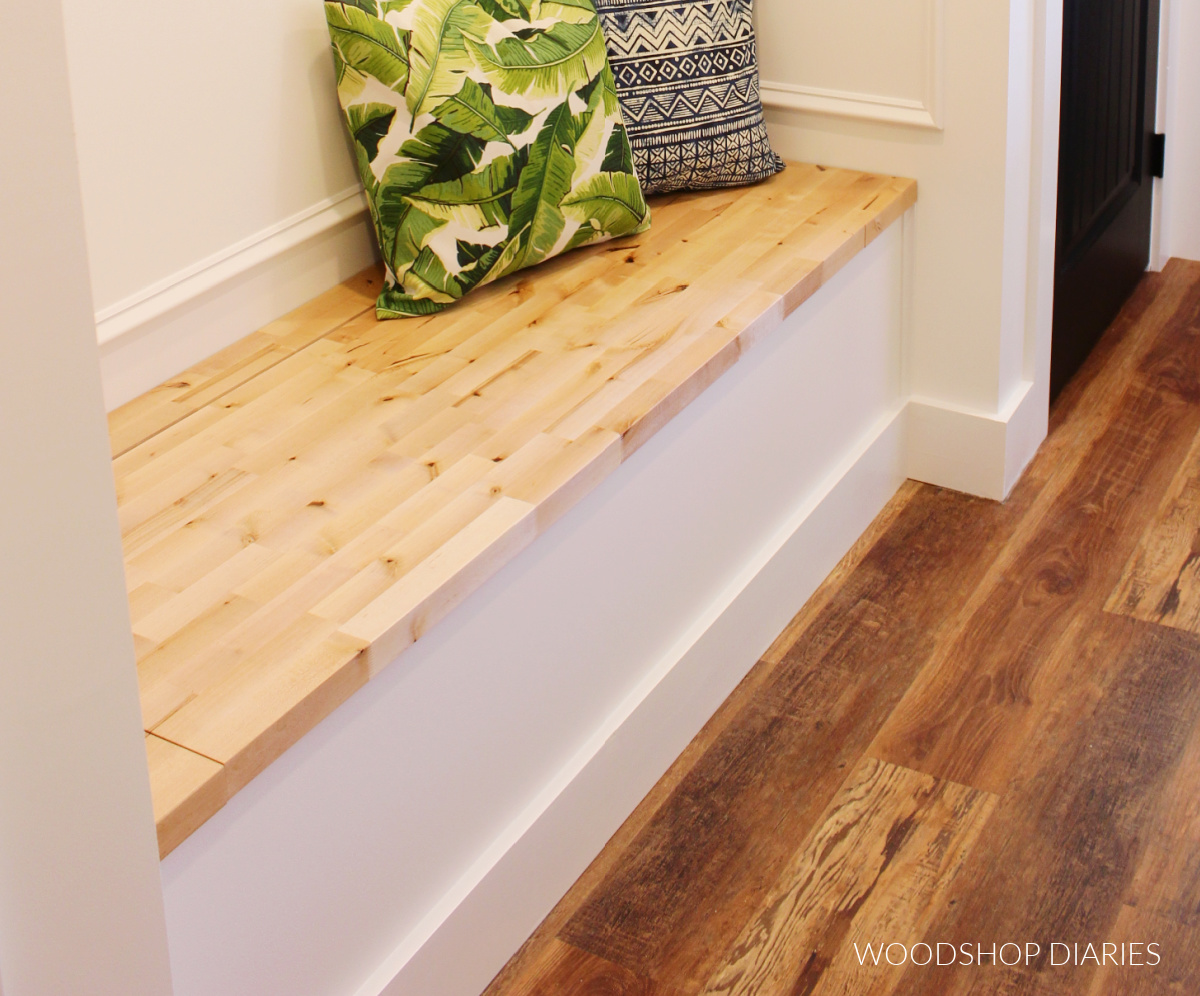 Close up of butcherblock top used as a bench seat on built in storage bench