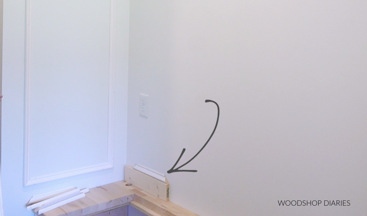 Bottom first piece of picture frame molding attached to wall