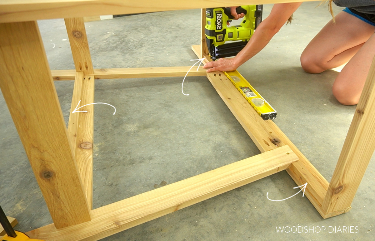 Shara nailing support pieces at top of potting bench cart