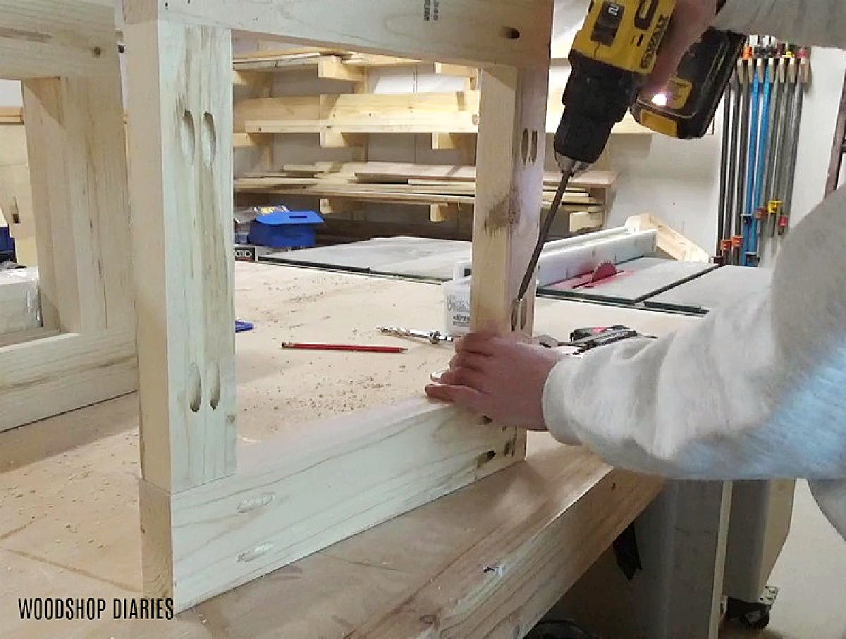 Shara Woodshop Diaries in workshop driving pocket holes in frame pieces of tree skirt box on workbench