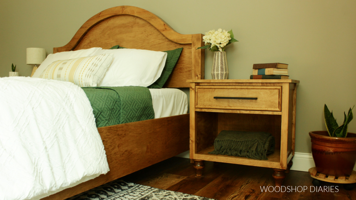 Completed DIY nightstand build next to arched headboard bed frame in guest bedroom