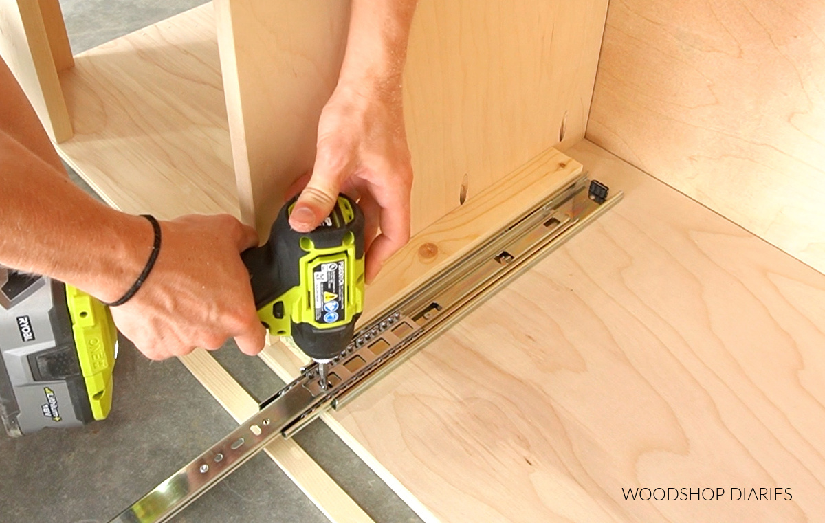 Close up of installing the drawer slide to bookshelf cabinet for hidden storage drawers