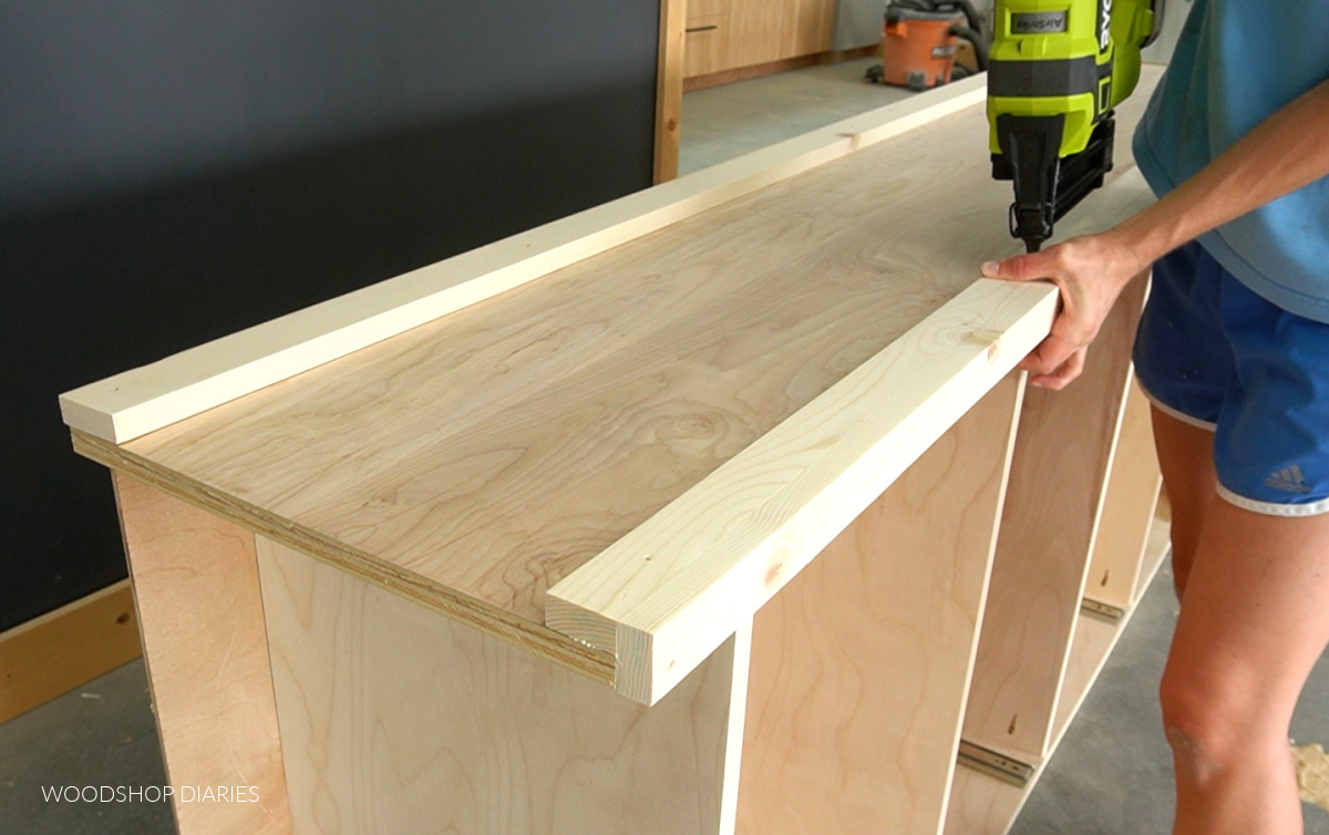 Shara Woodshop Diaries nailing trim onto bookshelf sides