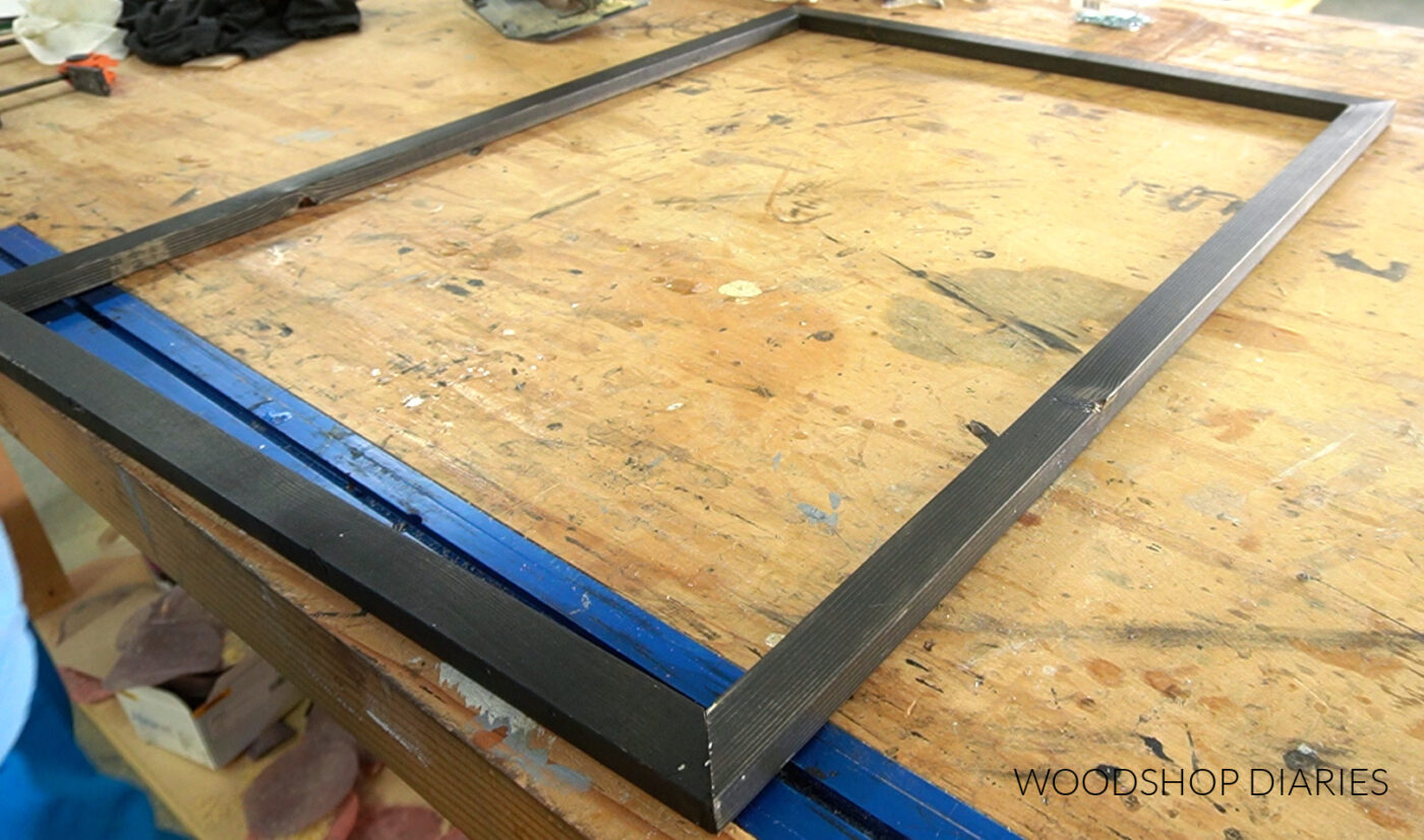 Inside picture frame pieces laid out on workbench--not assembled yet