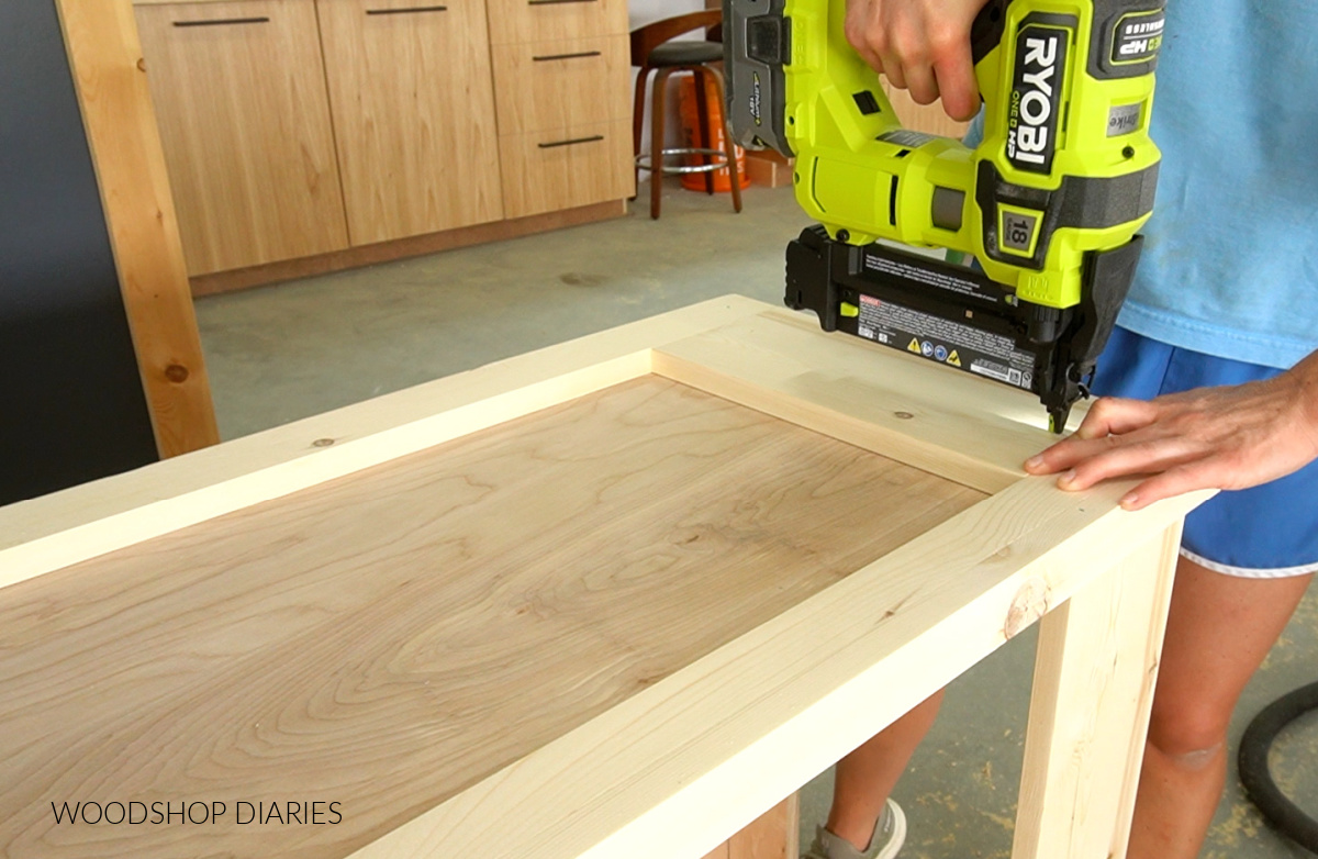 Using a nailer to install 1x6 trim at top of bookshelf side