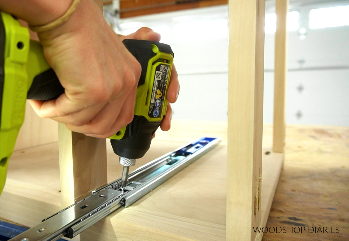 Close up of installing drawer slides into nightstand with drawer