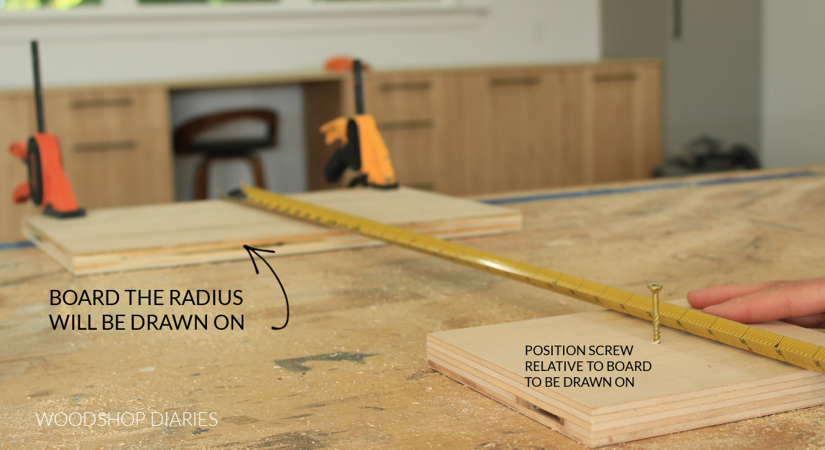 Positioning pivot screw relative to board on workbench to draw radius onto
