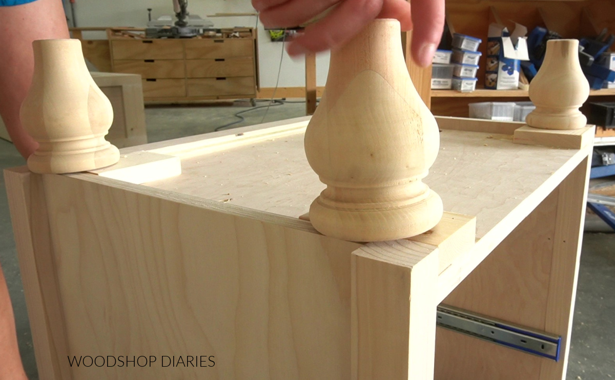 Screwing decorative furniture feet into threaded inserts on bottom of DIY nightstand