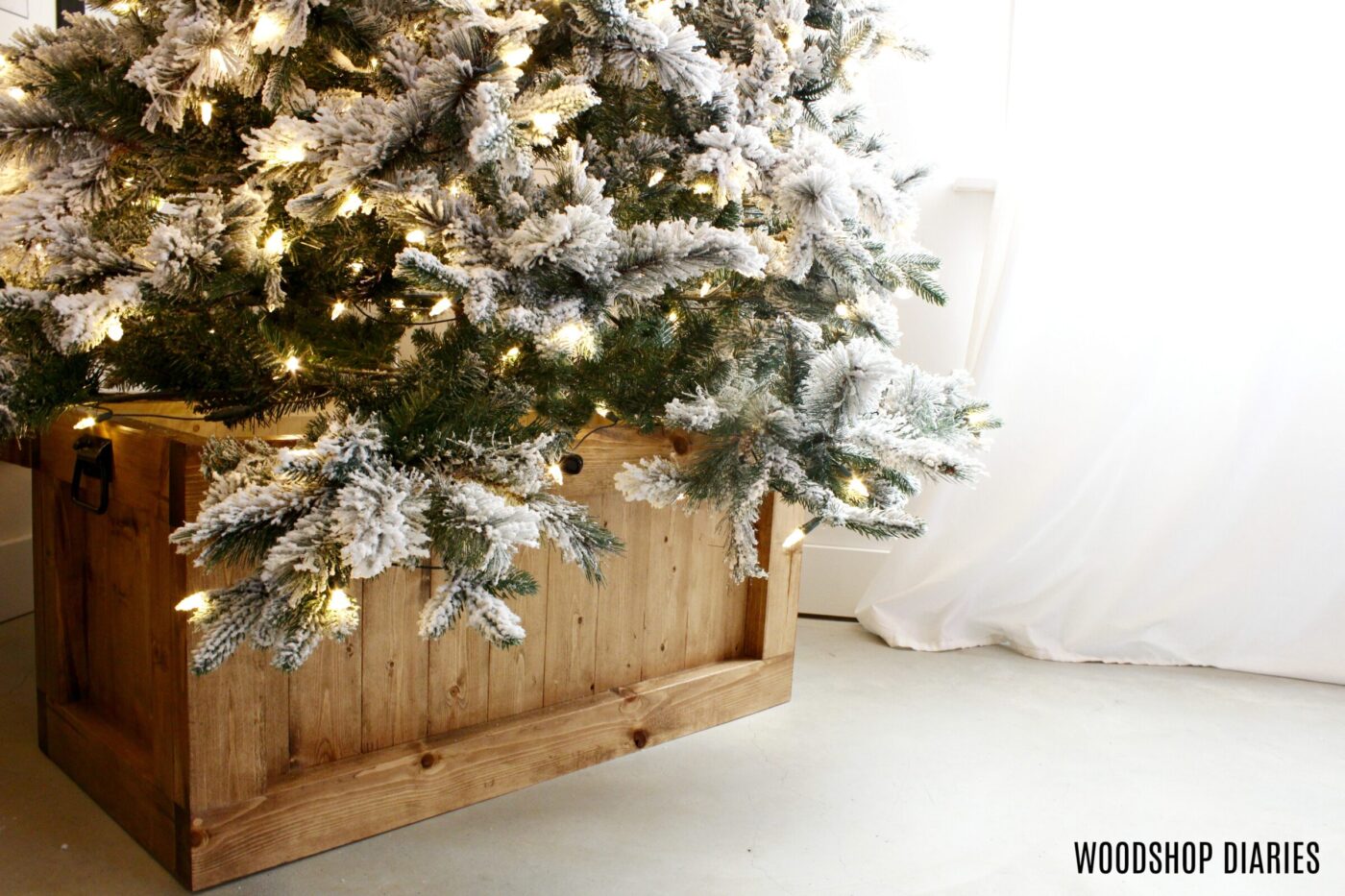 Christmas tree sitting in wooden box as tree skirt 