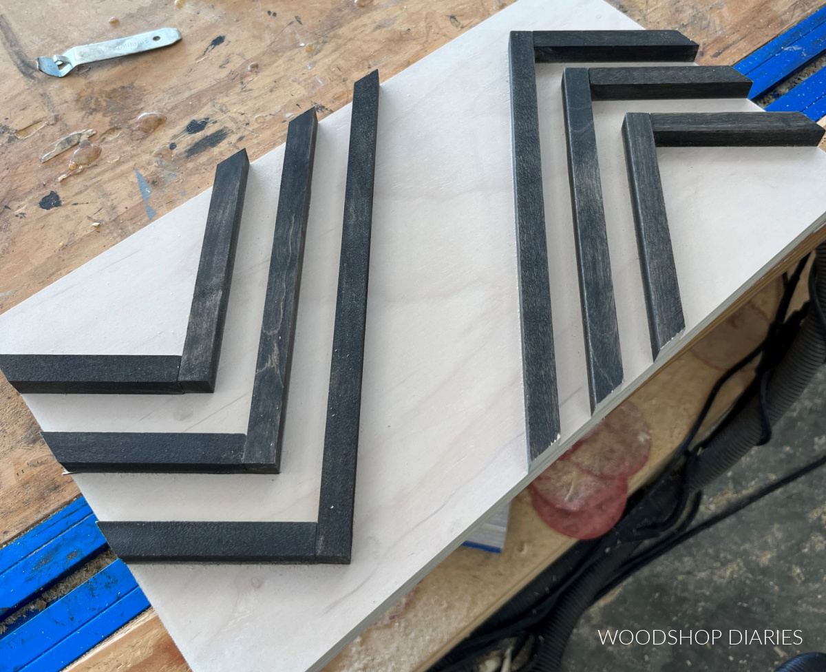 Geometric pattern glued onto backer board and trimmed to size laid on workbench