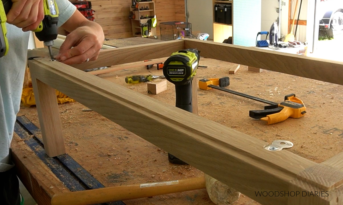 Shara Woodshop Diaries installing figure 8 brackets to cabinet base