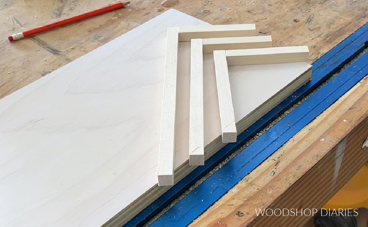 square wooden dowels trimmed to length, laid out in geometric pattern