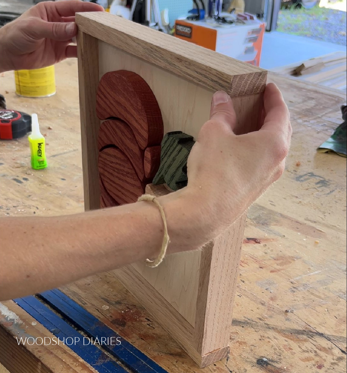 Gluing 1x2 red oak frame around DIY fall pumpkin sign project