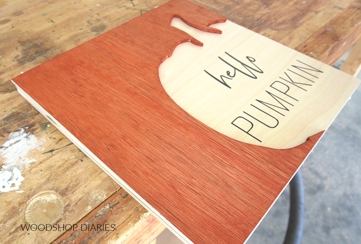 plywood pieces glued together so that hello pumpkin vinyl text shows inside pumpkin shape cut out