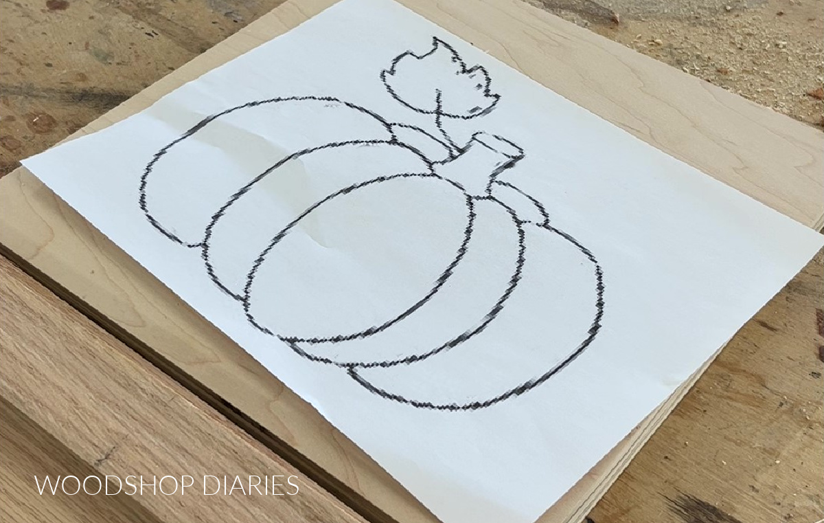 Pumpkin shape for sign printed on copy paper laying on maple plywood on workbench