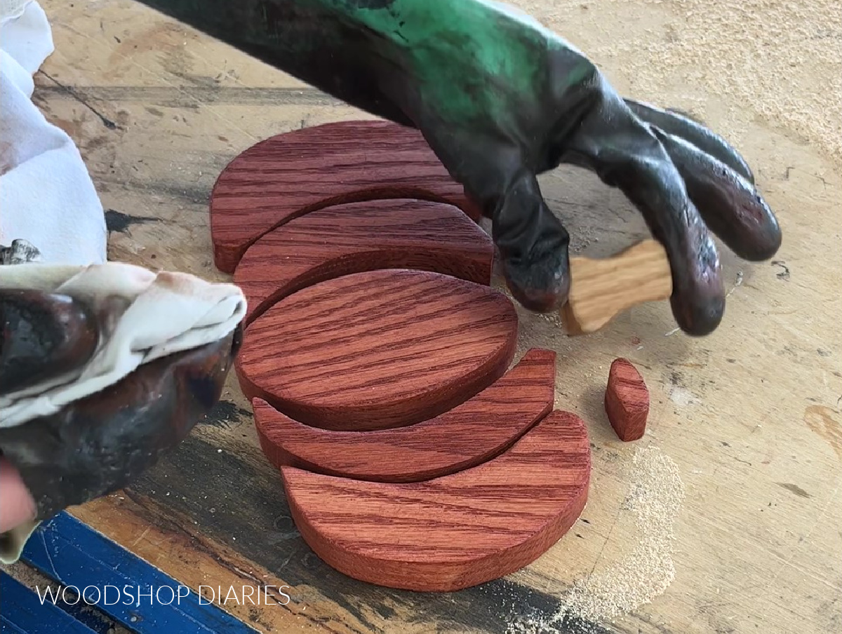 Shara Woodshop Diaries staining pieces of pumpkin cut out shape for DIY wooden fall sign