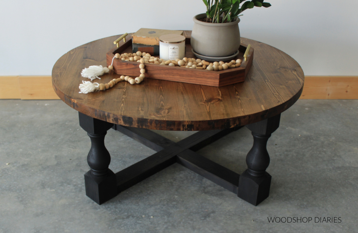 Round wooden coffee table with black base overhead view of top