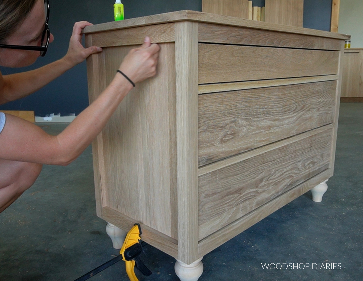 Shara Woodshop Diaries gluing trim pieces onto dresser sides