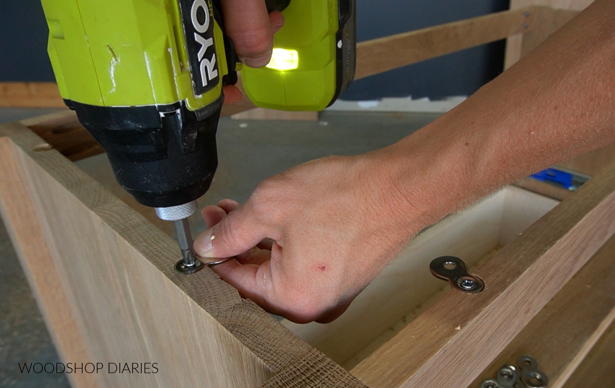 Close up installing figure 8 fasteners into dresser frame