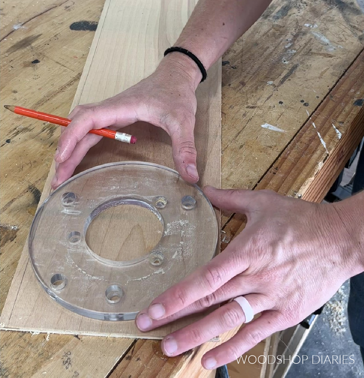 Placing clear router sub base on plywood jig board on workbench