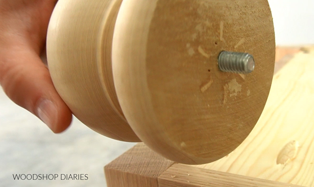 Close up of hanger bolt sticking out of wooden furniture foot