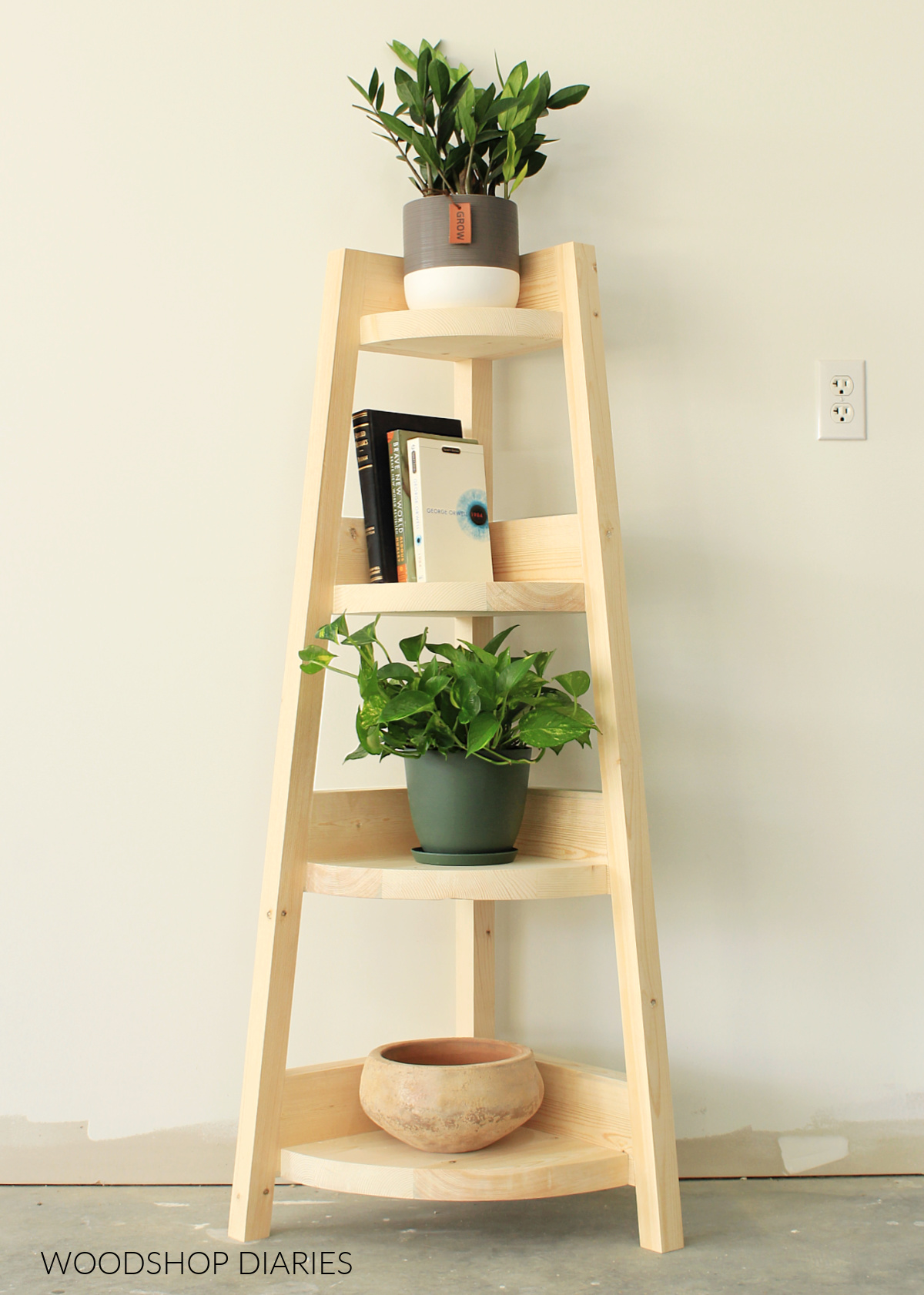 Completed spruce wood corner shelf with rounded shelf boards with books and plants displayed