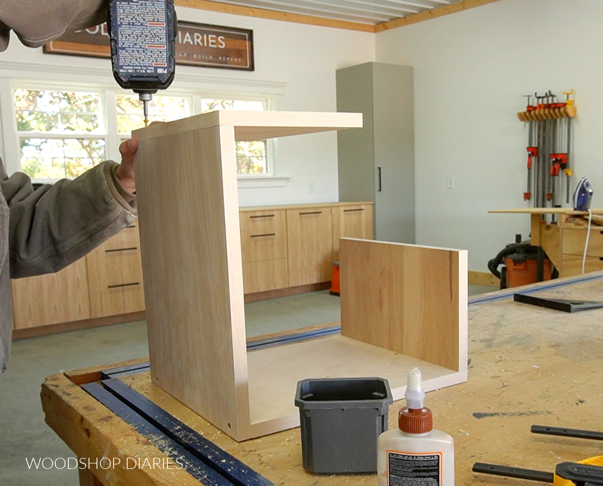 Shara Woodshop Diaries screwing partial geometric boxes together for black and wood bookshelf
