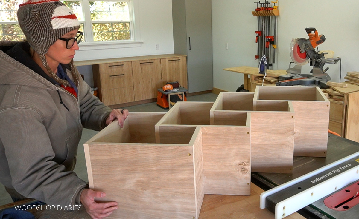 Shara Woodshop Diaries laying out modern bookshelf boxes in workbench