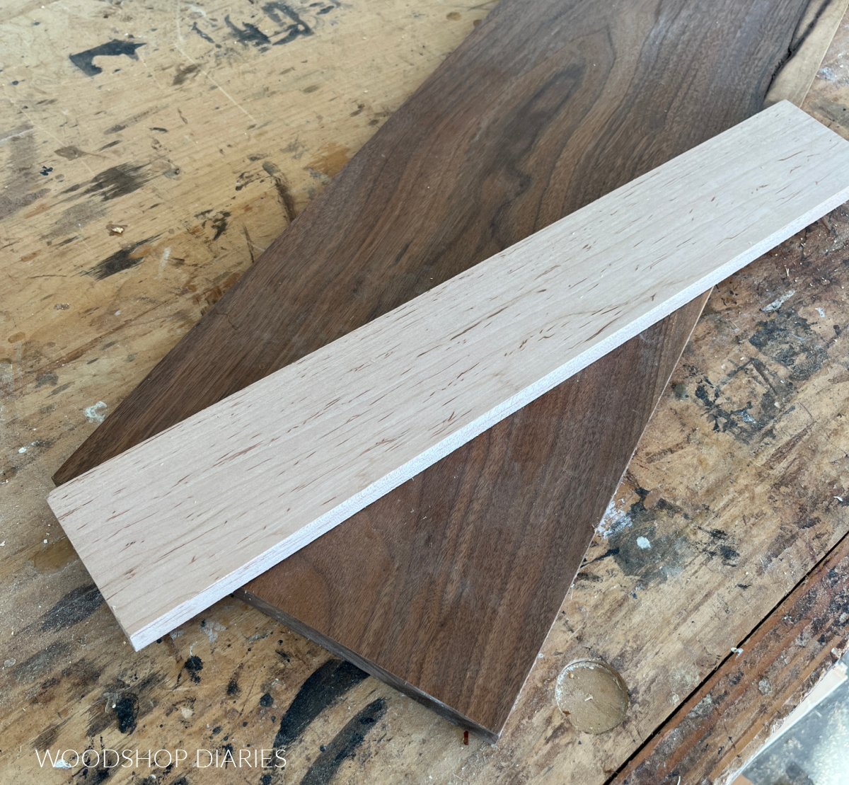 Walnut and maple boards laying on workbench