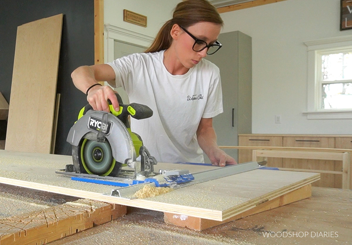 Shara Woodshop Diaries cutting down plywood sheet on workbench using circular saw and Kreg Rip Cut