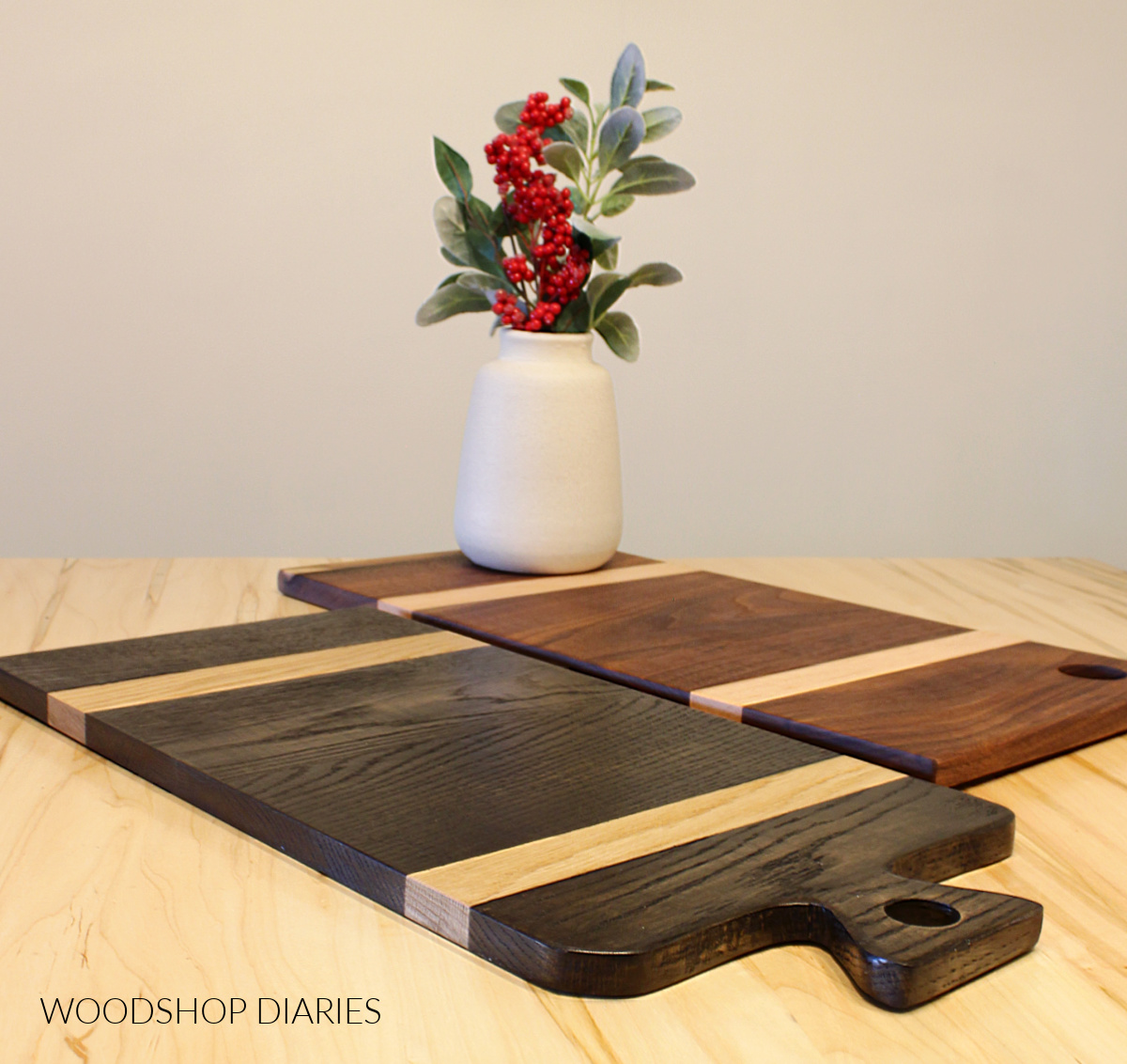 two different styles of two tone cutting and serving boards laid out on table top