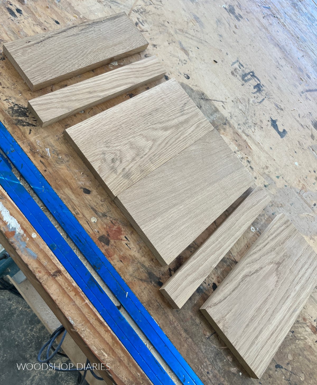 White oak charcuterie board pieces cut to size and laid out on workbench