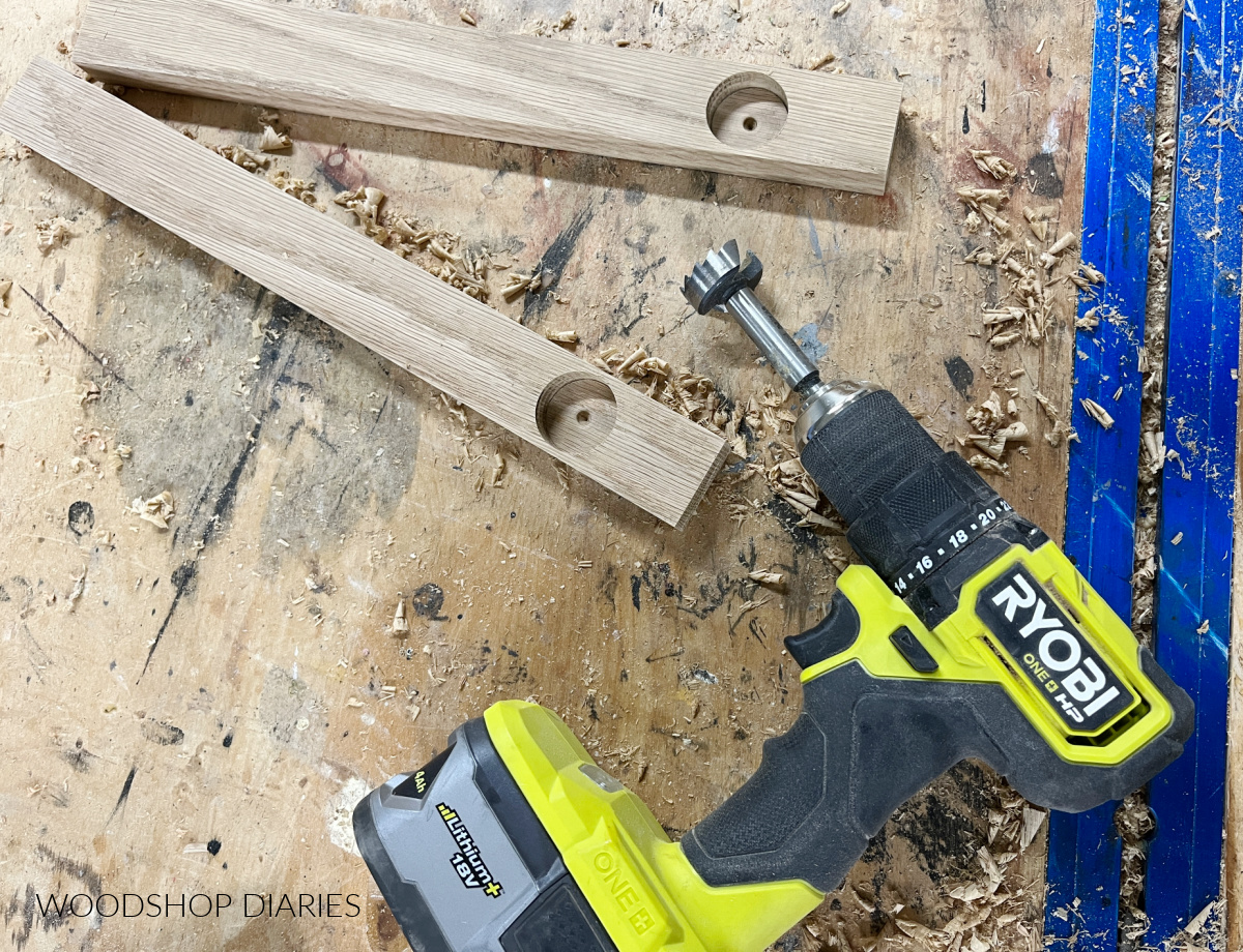 Drill and wood shavings on stained wood workbench