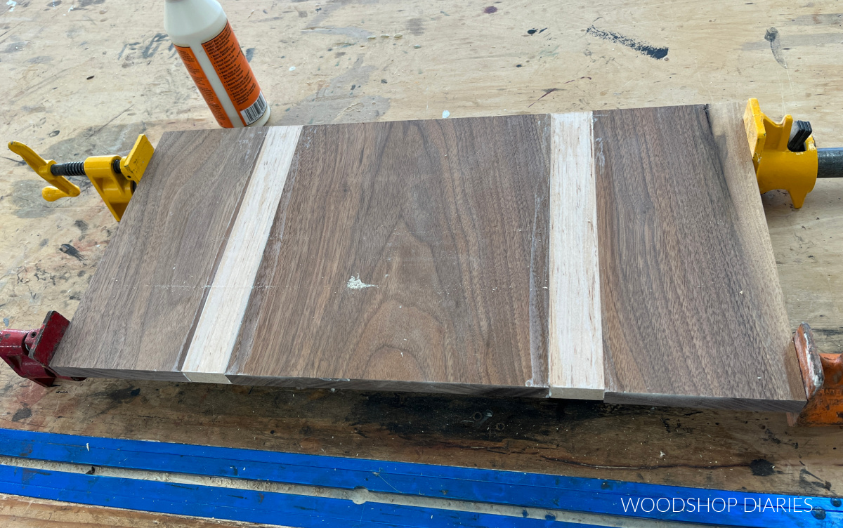 maple and walnut DIY cutting board in clamps with glue