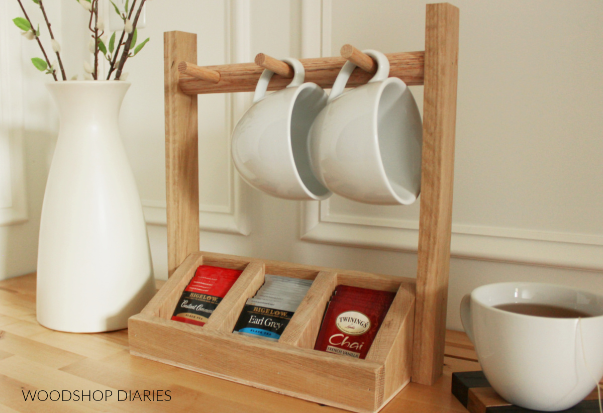 Completed DIY tea storage box made of oak wood with wooden dowel mug holder