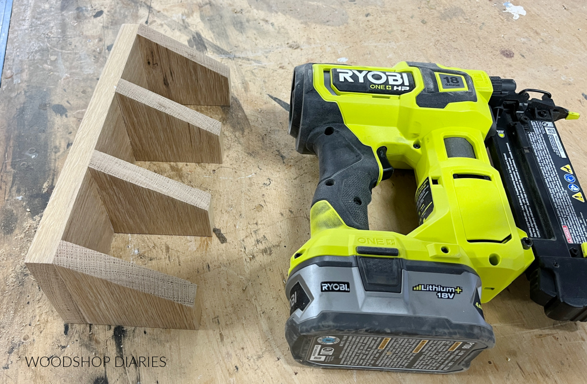 Divider blocks glued and nailed to back tea box board next to nailer on workbench