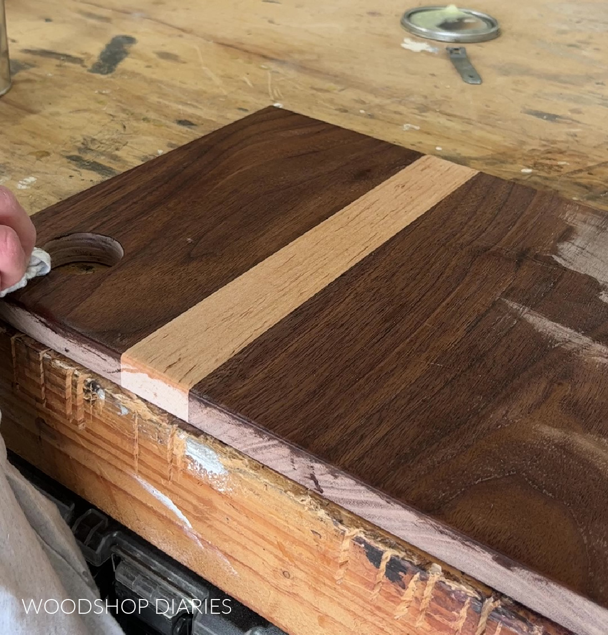 applying an oil finish to maple and walnut cutting board