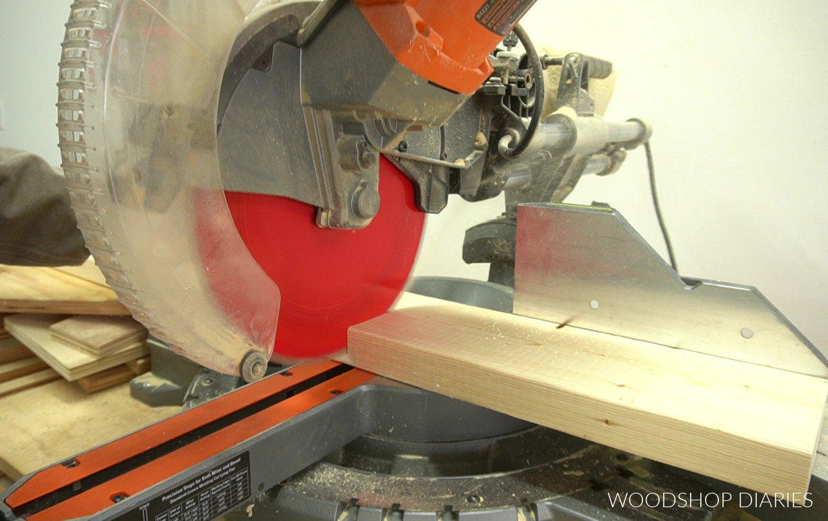 Close up of miter saw cutting 2x6s