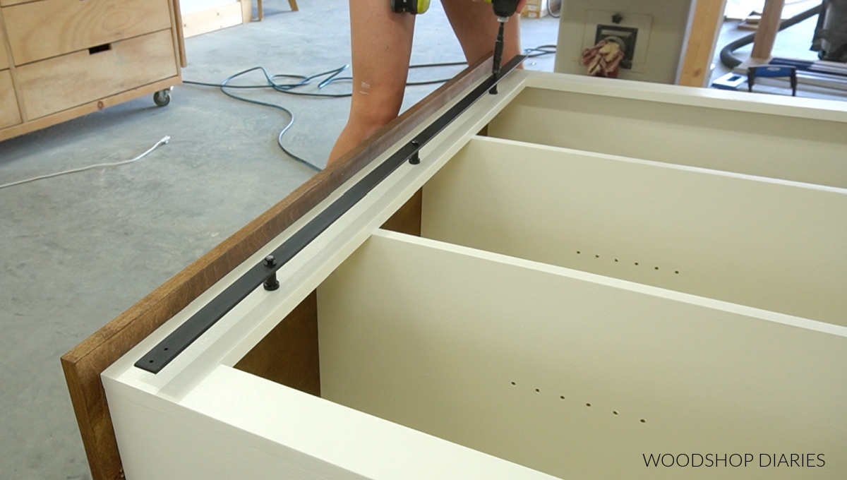 Installing sliding door rail onto cabinet