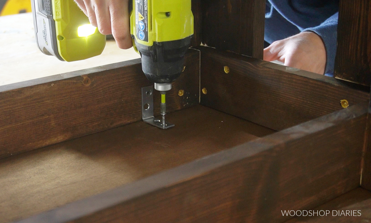 Close up of L brackets used to secure bench frame to bench top