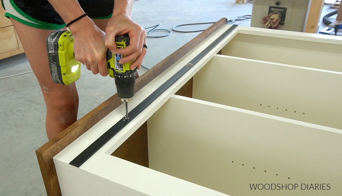 Predrilling holes through sliding door rail