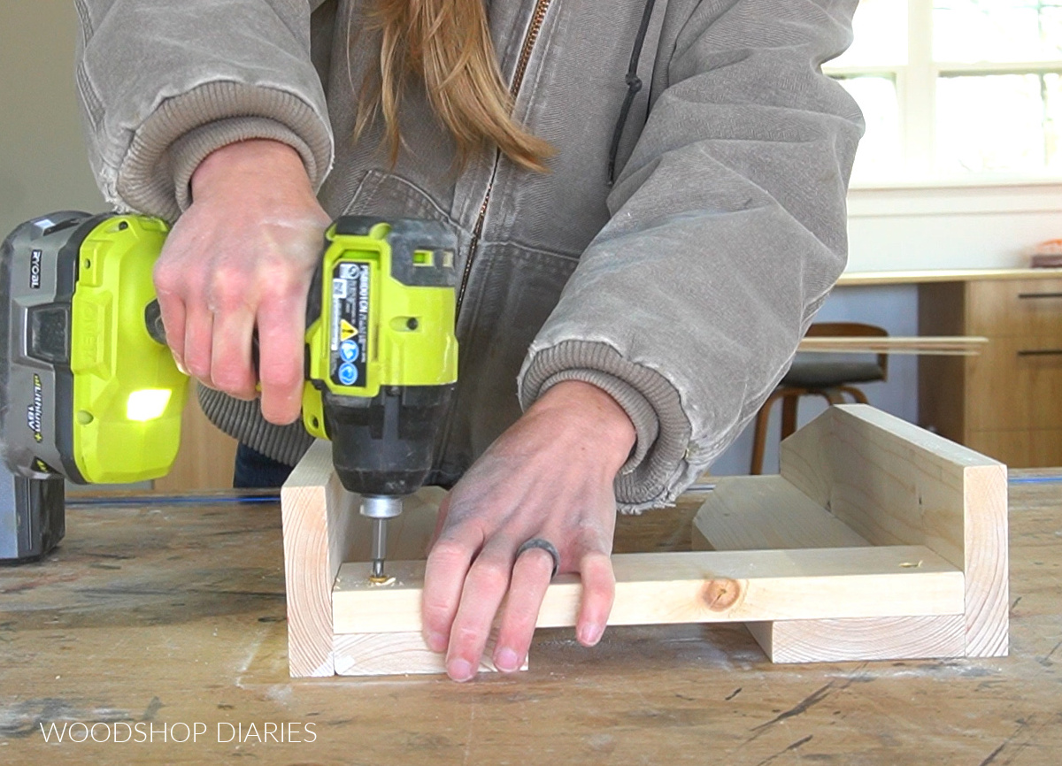 Using screws to secure the top frame piece between simple bench legs