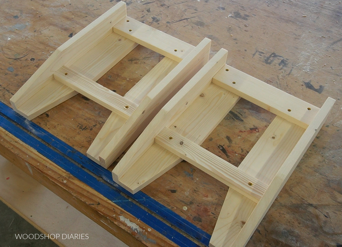 Two identical bench side frames assembled on workbench