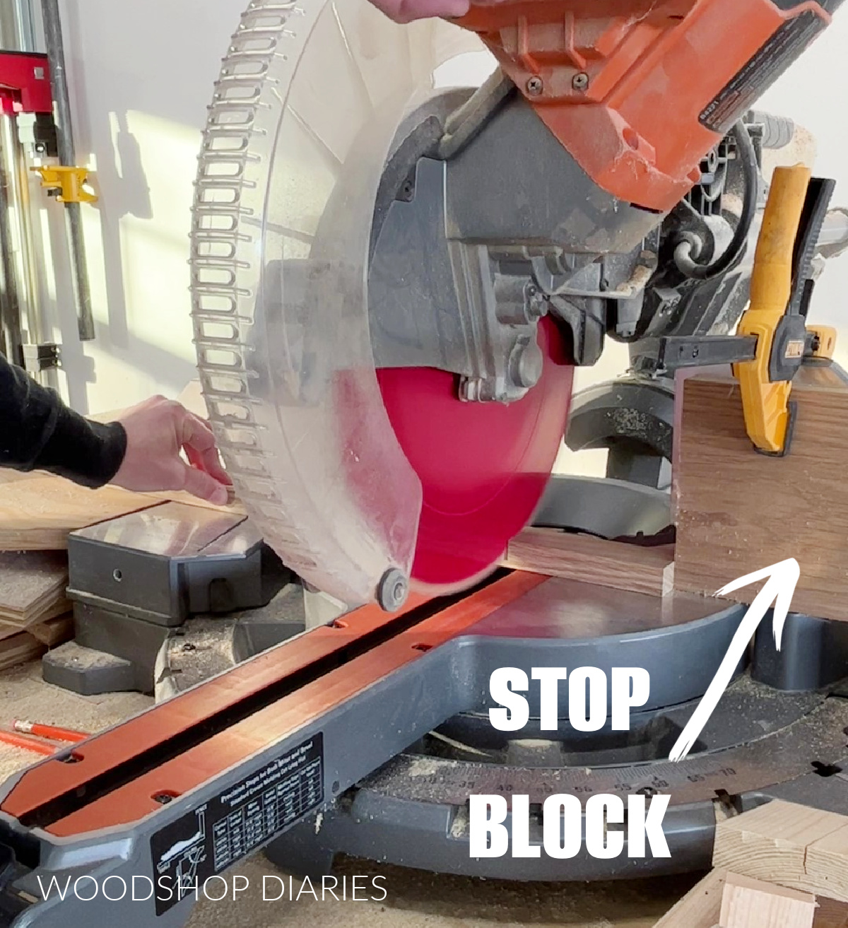Stop block clamped to miter saw for consistent length cuts