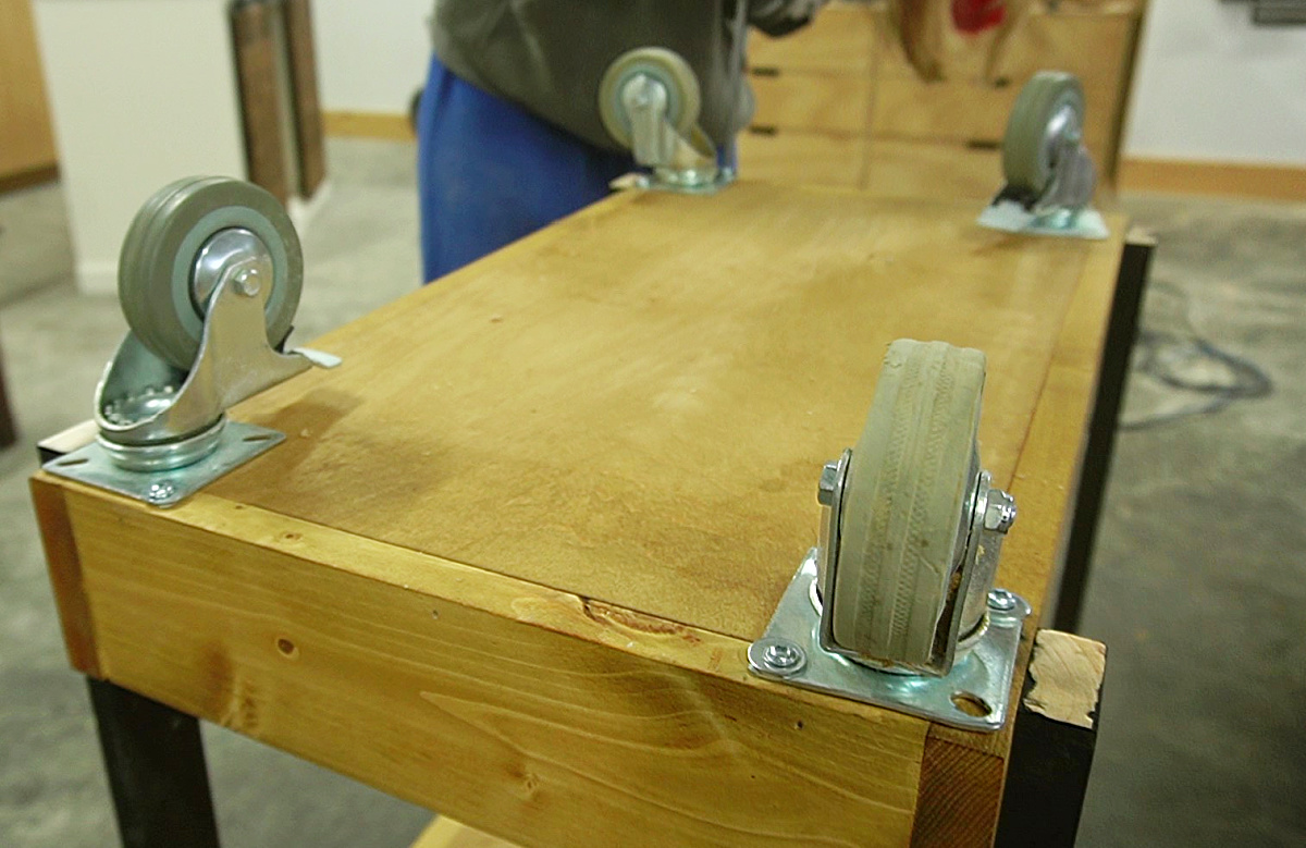 Attaching casters to bottom of rolling storage cart